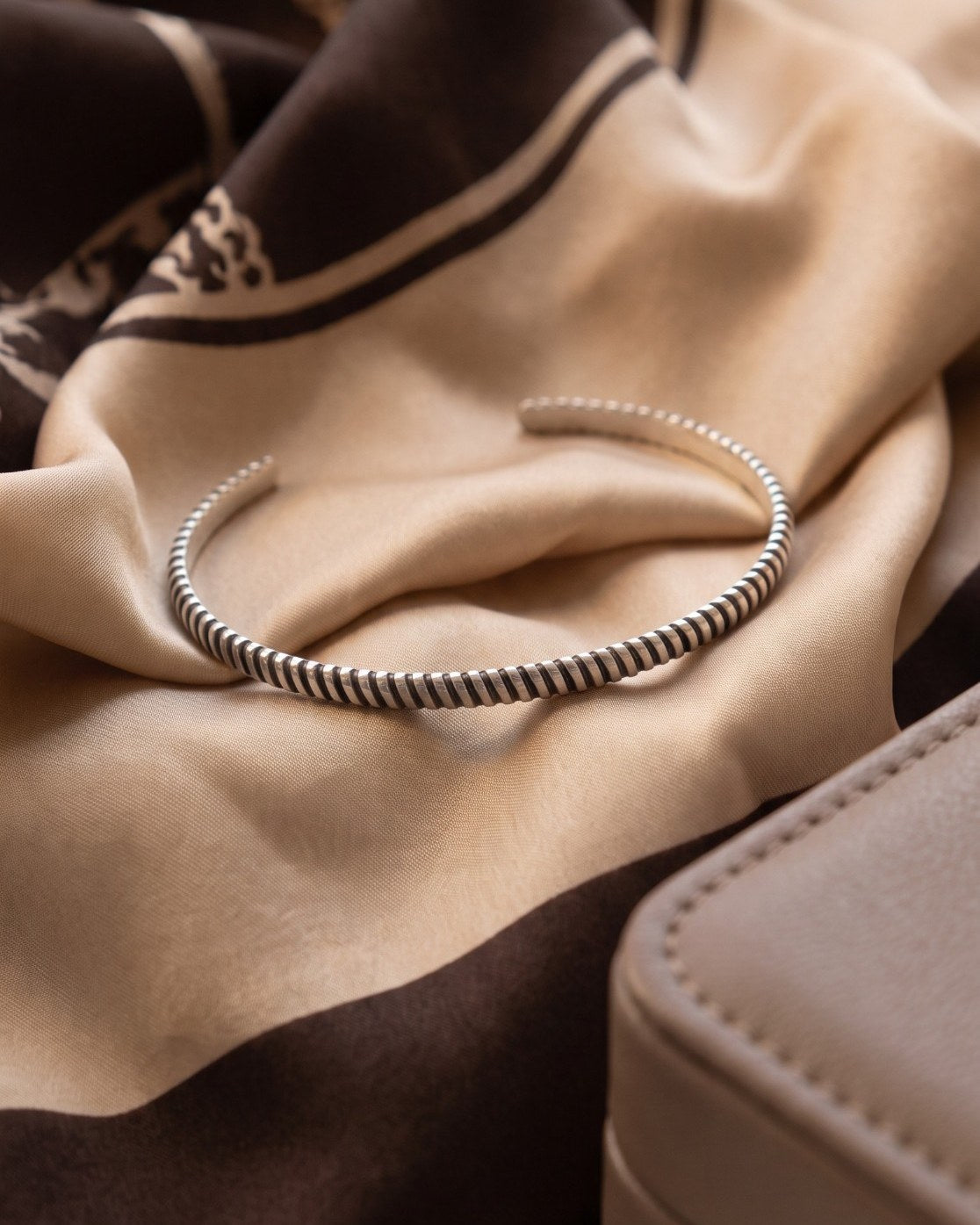 Curled Cuff aus 925 Sterlingsilber auf Seidentuch